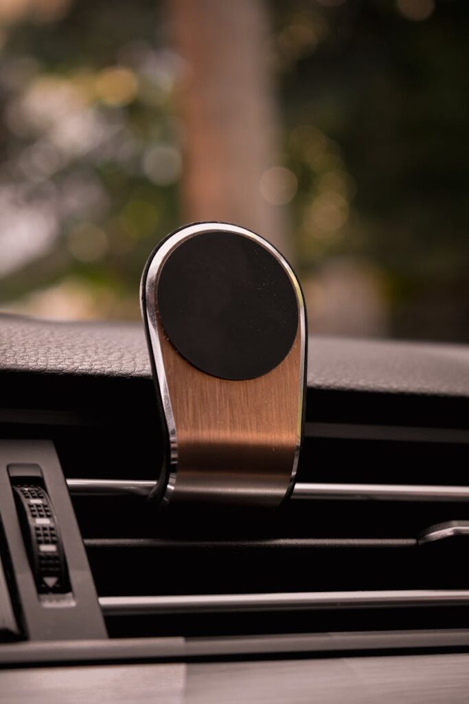 15 Best Gift Ideas for Car Enthusiasts In 2025 11 Close-up of a metallic magnetic phone holder on car air vent.