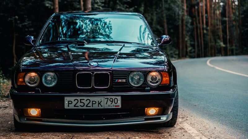 BMW M5 E34: The Hand-Built M5 3 Black BMW E34 M5 parked on the side of the road