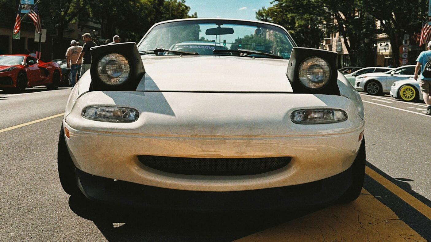 The Real Reason Pop-Up Headlights Disappeared (And Why They Must Return) 5 A white Mazda MX5 with pop-up headlights