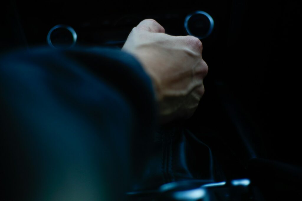 Why Manual Transmissions Are Actually Making a Comeback 2 A person driving a car with their hand on the manual gearbox